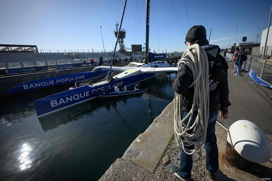 Maxi Banque Populaire XI crosses the finish line, captured by Loic Venance for AFP.