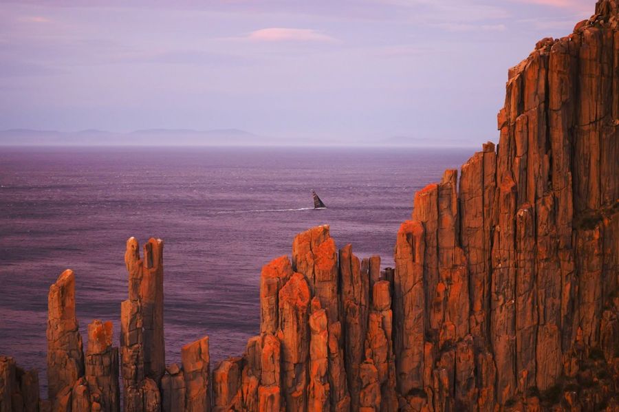The dramatic Organ Pipes provide a stunning backdrop as a competitor sails past.