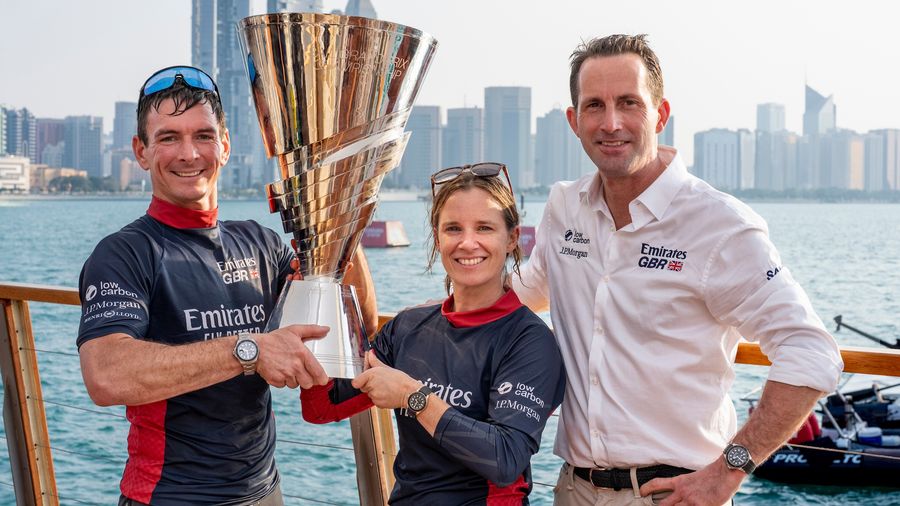 Dylan Fletcher, Hannah Mills and Ben Ainslie with the Rolex SailGP trophy during the 2025 season.