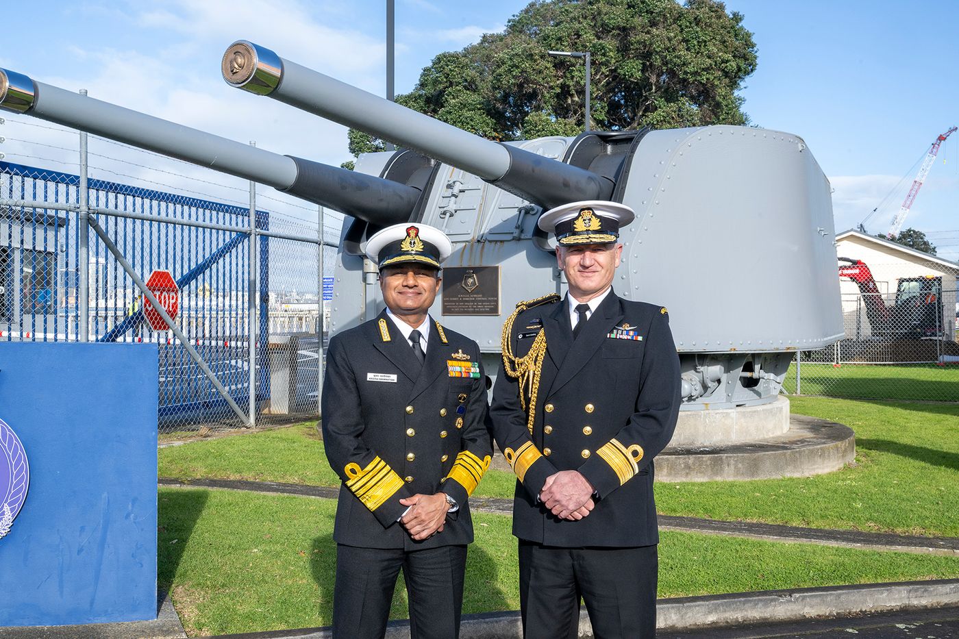 Admiral Swaminathan (left) and Rear Admiral Golding pose in front of the gun turret from HMNZS Achilles, also Indian Naval Ship INS Delhi from 1948