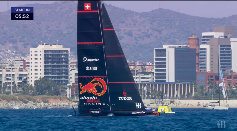 Alinghi needs a tow start to get up in such slight winds. The race has already been pushed back about 25 minutes due to slack winds