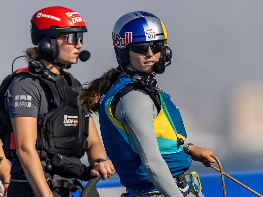 Martine Grael, driver of Mubadala Brazil SailGP Team, tries out the role of wing trimmer as she works with Anne-Marie Rindom, strategist of ROCKWOOL Denmark SailGP Team, onboard Mubadala Brazil SailGP Team F50 catamaran during the SailGP Womens Performance Camp Delivered by DP World in Dubai, UAE. Tuesday 26 November 2024. Photo: Simon Bruty for SailGP. Handout image supplied by SailGP