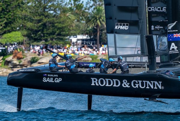 New Zealand SailGP Team helmed by Peter Burling pass spectators on Shark Island on Race Day 1 of the KPMG Australia Sail Grand Prix in Sydney, Australia. Saturday 8 February 2025. Rolex SailGP Championship Event 3 Season 2025. Photo: Bob Martin for SailGP.