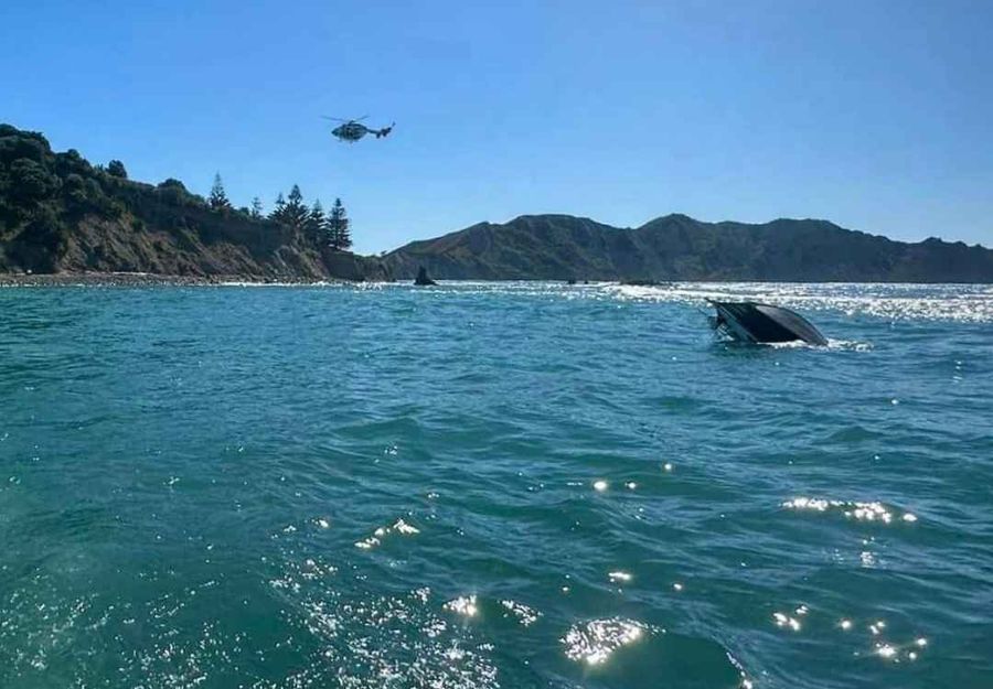 Capsized boat off the coast of capsized near Tuamotu Island, just off Sponge Bay, Gisborne. Image source Eastland Rescue Helicopter.