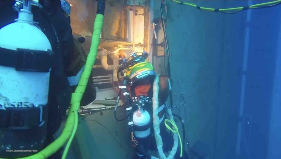 Cutting hole in the hull to extract oil from the wreck