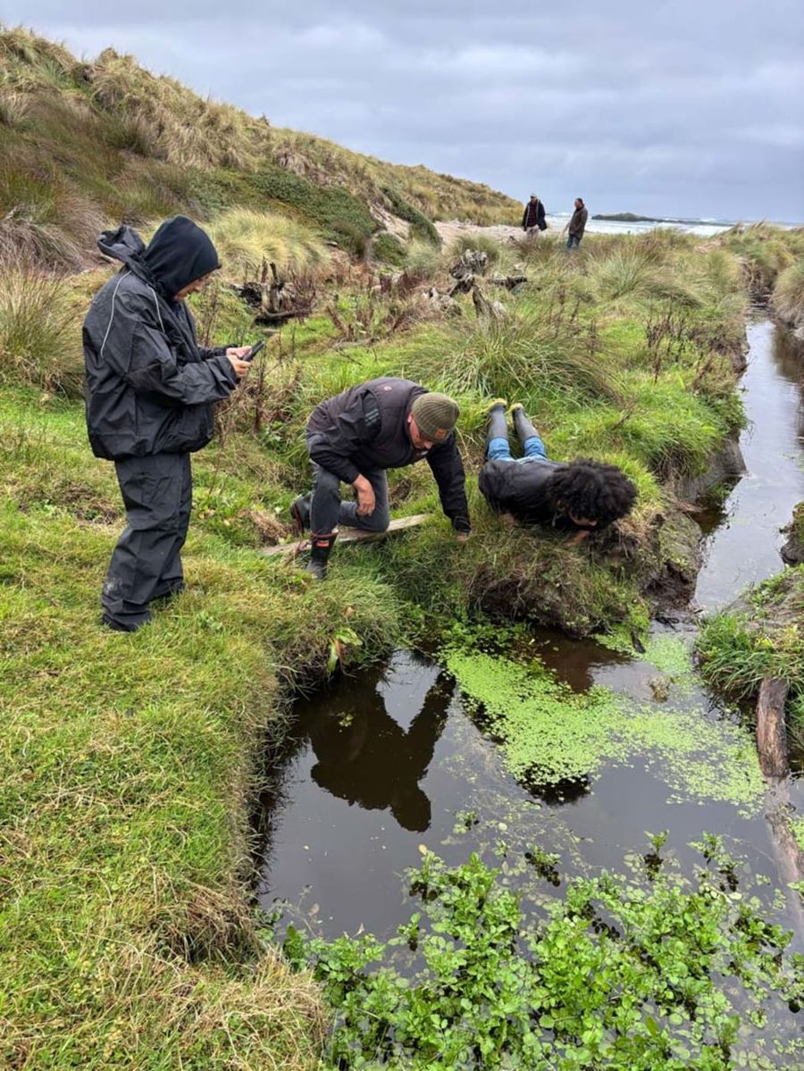 Dr-Kahutoi-Te-Kanawa-Professor-Sir-Derek-Lardelli-and-Nikau-Dix-at-the-creek-near-the-excavation-site.-Photo-SuppliedManatū-Taonga-Ministry-for-Culture-and-Heritage.jpeg