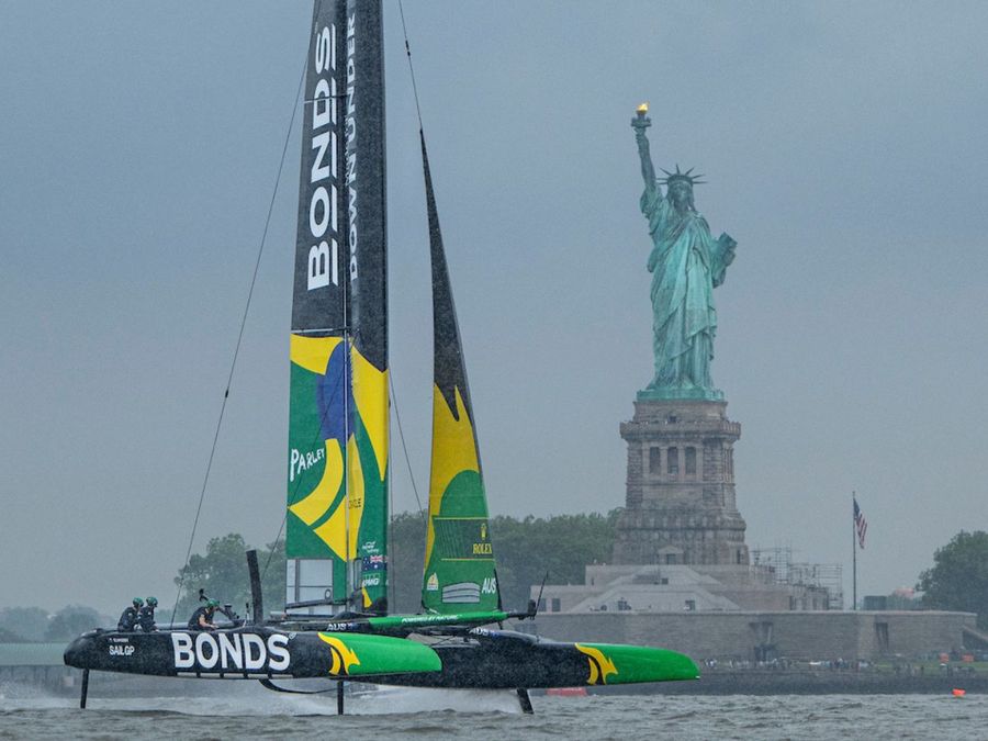 BONDS Flying Roos SailGP Team helmed by Tom Slingsby passes the Statue of Liberty on Race Day 1 of the Mubadala New York Sail Grand Prix in New York, USA. Saturday 7 June 2025. Rolex SailGP Championship Event 6 Season 2025. Photo: Ricardo Pinto for SailGP.