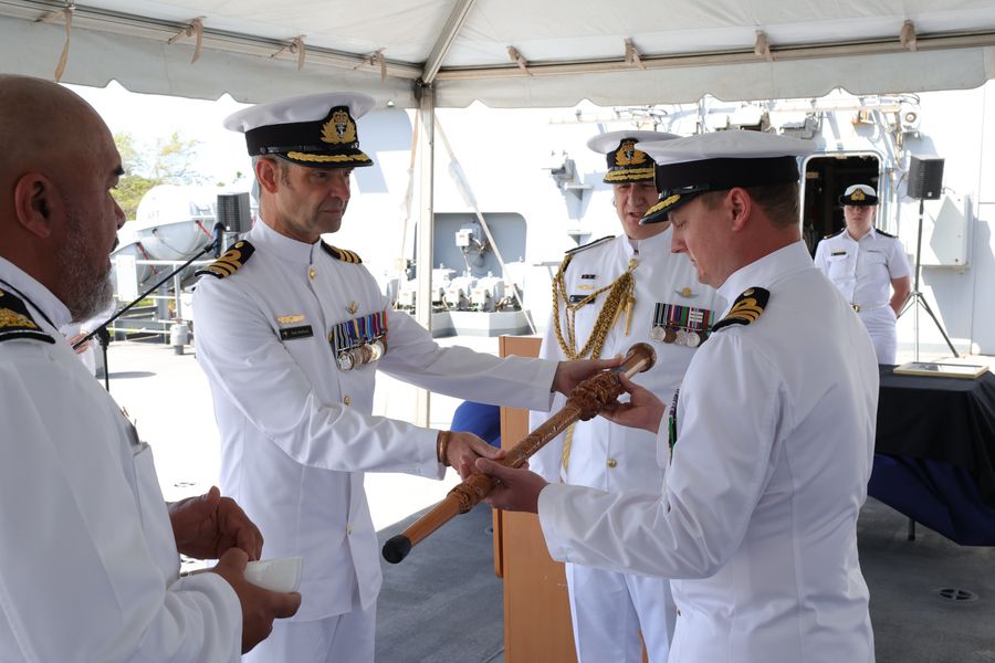 Former Commanding Officer of HMNZS Aotearoa, Commander Rob Welford, passes over the ship’s symbol of command to the incoming Commanding Officer, Commander Kane Sutherland at a ceremony in Hawaii