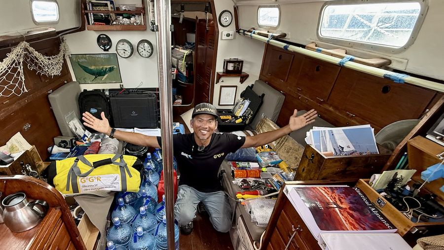 Canadian skipper Isa Rosli grins after passing his GGR safety inspection aboard the OE 32 Olleanna, with mandatory gear spread through the cabin, one milestone down and final packing still to go.