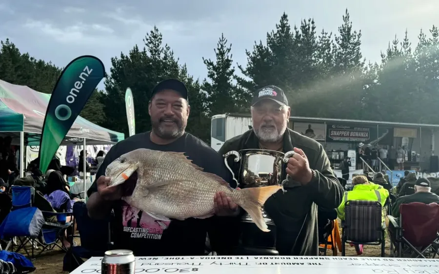 Harley-Ra-with-his-winning-fish-the-trophy-and-his-father-John-Ra-known-in-Kaitāia-for-his-expertise-in-making-fishing-rigs.-Photo-Supplied-.webp