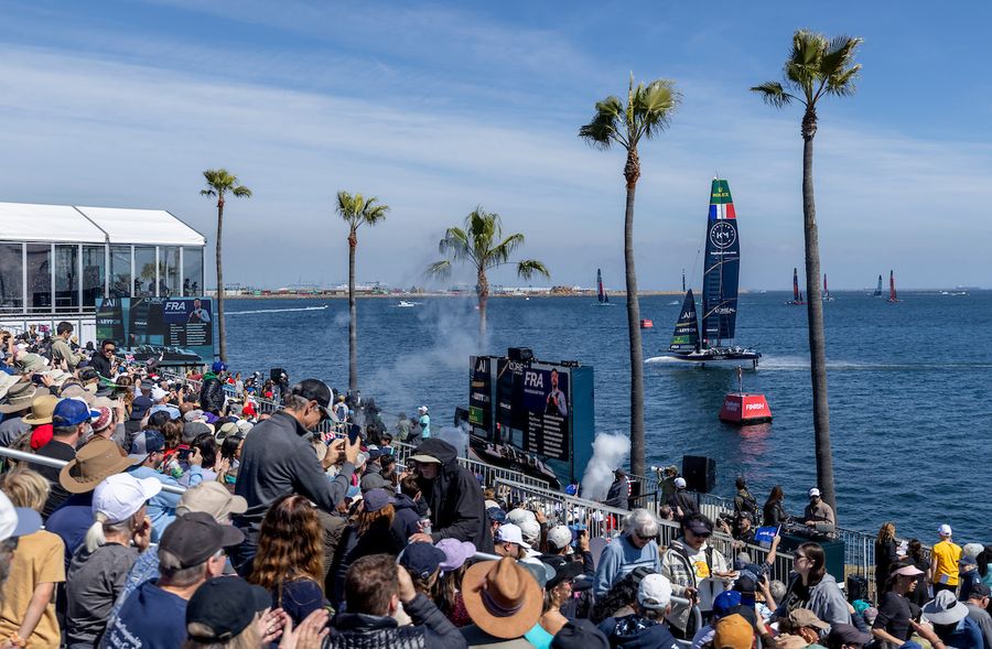 Spectators watch from the Grandstand as France SailGP Team helmed by Quentin Delapierre sails past on Race Day 1 of the Rolex Los Angeles Sail Grand Prix held in the Port of Los Angeles, California, USA. Saturday 15 March 2025. Rolex SailGP Championship Event 4 Season 2025. Photo credit: Jed Jacobsohn for SailGP.