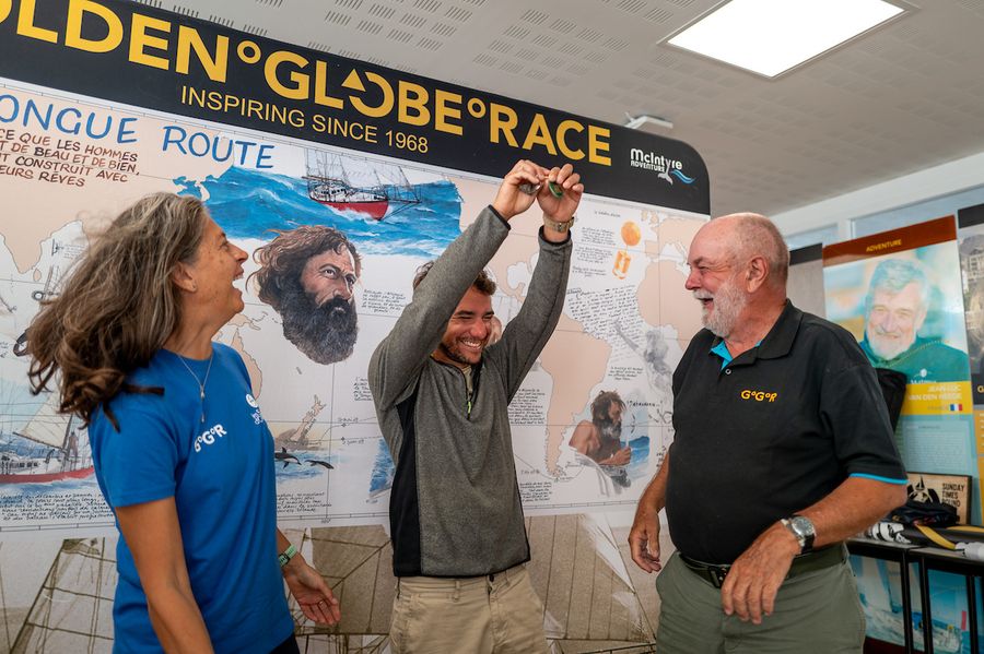 Israeli skipper Daniel Pinsky becomes the first GGR 2026 entrant to receive his official Green Card, confirming he's cleared to start, pictured beside an image of his sailing hero Bernard Moitessier.