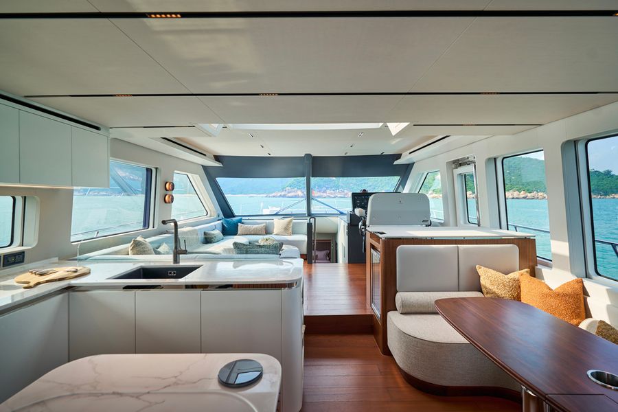 Looking forward through the CLB65 SUV’s main deck, with the galley to port, the breakfast nook to starboard and the saloon and helm beyond.