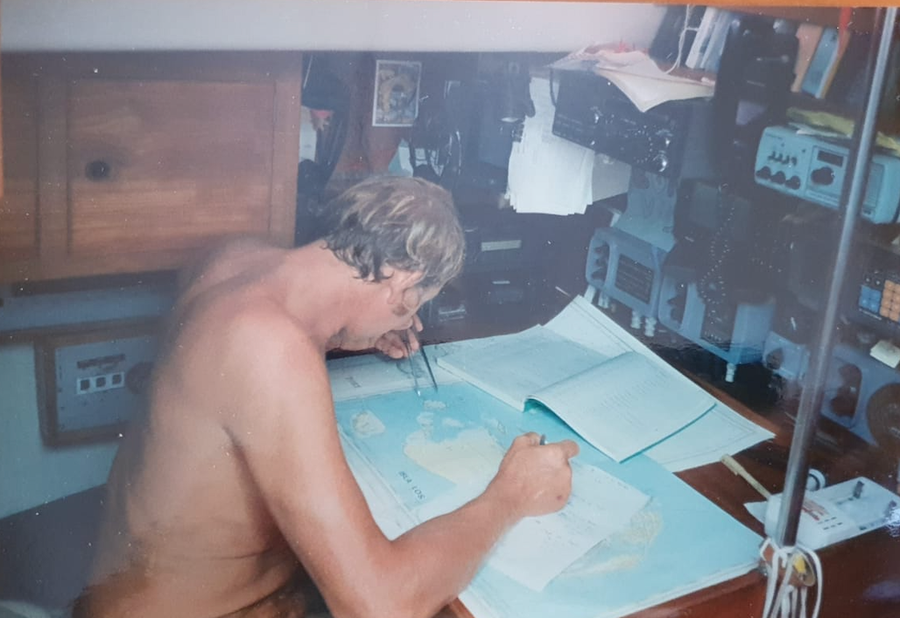 Tony pouring over the marine paper charts. Paper charts were imperative; and still are today.