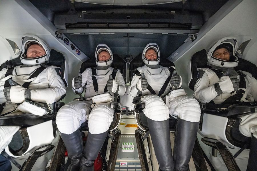 NASA astronaut Butch Wilmore, left, Roscosmos cosmonaut Aleksandr Gorbunov, second from left, and NASA astronauts Nick Hague, second from right, and Suni Williams, right are seen inside a SpaceX Dragon spacecraft onboard the SpaceX recovery ship MEGAN shortly after having landed in the water off the coast of Tallahassee, Florida, Tuesday, March 18, 2025. Hague, Gorbunov, Williams, and Wilmore are returning from a long-duration science expedition aboard the International Space Station. Photo Credit: (NASA/Keegan Barber)