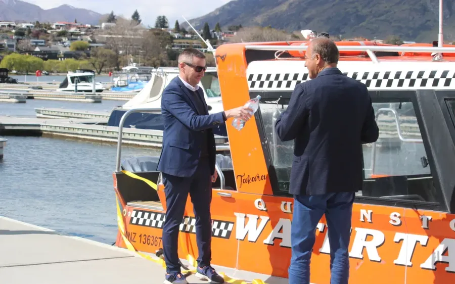 Otago-Regional-Councils-Julian-Phillips-and-Watersports-co-owner-Iraj-Barabi-at-a-ribbon-cutting-ceremony-in-Queenstown-on-Monday.-Photo-RNZ-Katie-Todd.webp
