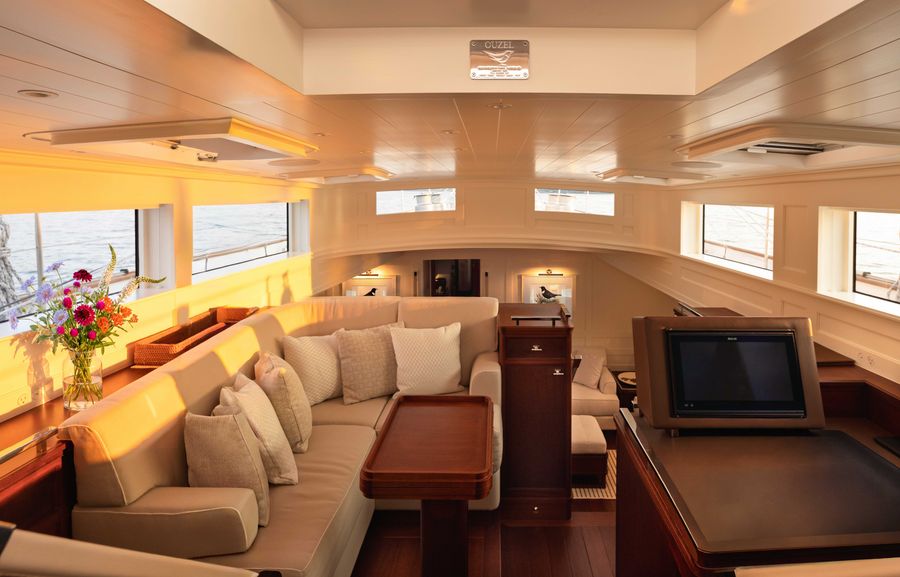 Ouzel’s pilothouse combines wraparound seating, a central table, and a dedicated navigation station.