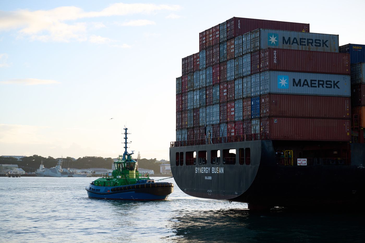 Port of Auckland tugboat Sparky manoeuvring alongside a large container ship.jpg