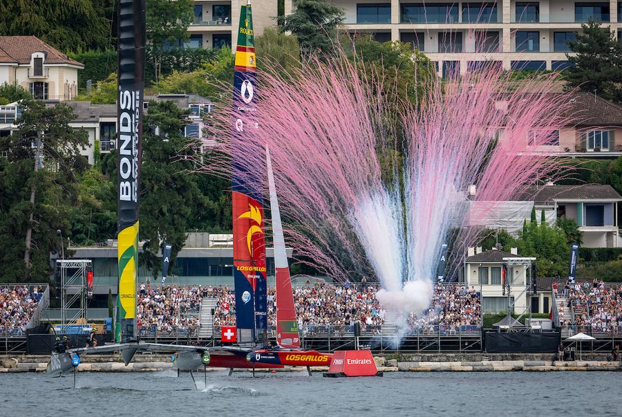 Pyrotechnics are released in front of the grandstand as Los Gallos SailGP Team driven by Diego Botin cross the finish line to win the final race ahead of BONDS Flying Roos SailGP Team on Race Day 2 of the Switzerland Sail Grand Prix in Geneva, Switzerland. Sunday 20 September 2026. Rolex SailGP Championship Event 11 2026 Season. Photo: Jonathan Nackstrand for SailGP