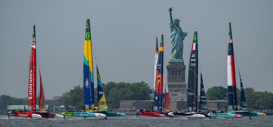 USA SailGP Team helmed by Taylor Canfield lead France SailGP Team, Spain SailGP Team, Germany SailGP Team presented by Deutsche Bank, Mubadala Brazil SailGP Team and Emirates Great Britain SailGP Team past the Statue of Liberty during a practice session ahead of the Mubadala New York Sail Grand Prix in New York, USA. Thursday 5 June 2025. Rolex SailGP Championship Event 6 Season 2025. Photo: Ricardo Pinto for SailGP.