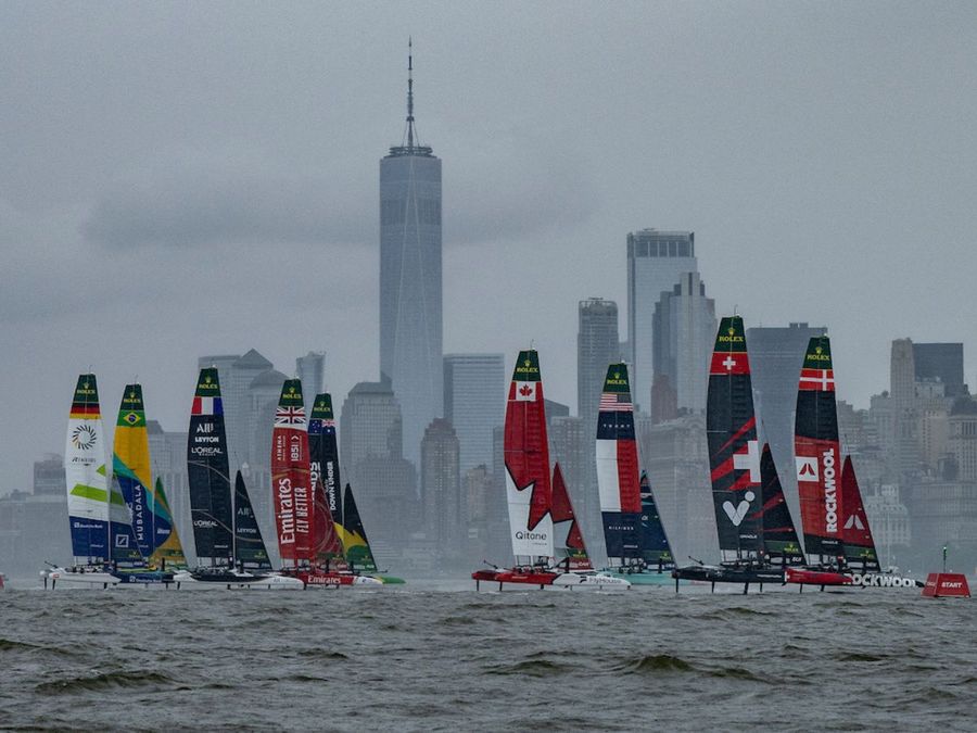 ROCKWOOL Denmark SailGP Team helmed by Nicolai Sehested and Switzerland SailGP Team helmed by Sebastien Schneiter lead the fleet past the One World Trade Centre and New York City skyline on Race Day 1 of the Mubadala New York Sail Grand Prix in New York, USA. Saturday 7 June 2025. Rolex SailGP Championship Event 6 Season 2025. Photo: Ricardo Pinto for SailGP. Handout image supplied by SailGP