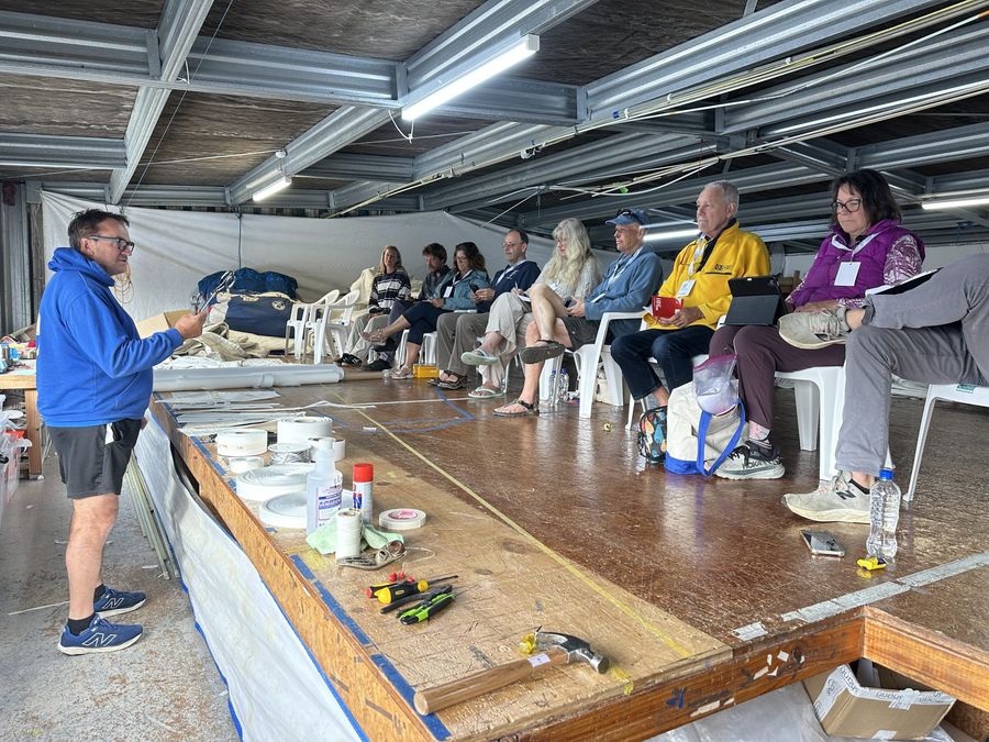 Roger-from-North-Sails-demonstrates-how-to-repair-sails-at-sea.jpeg