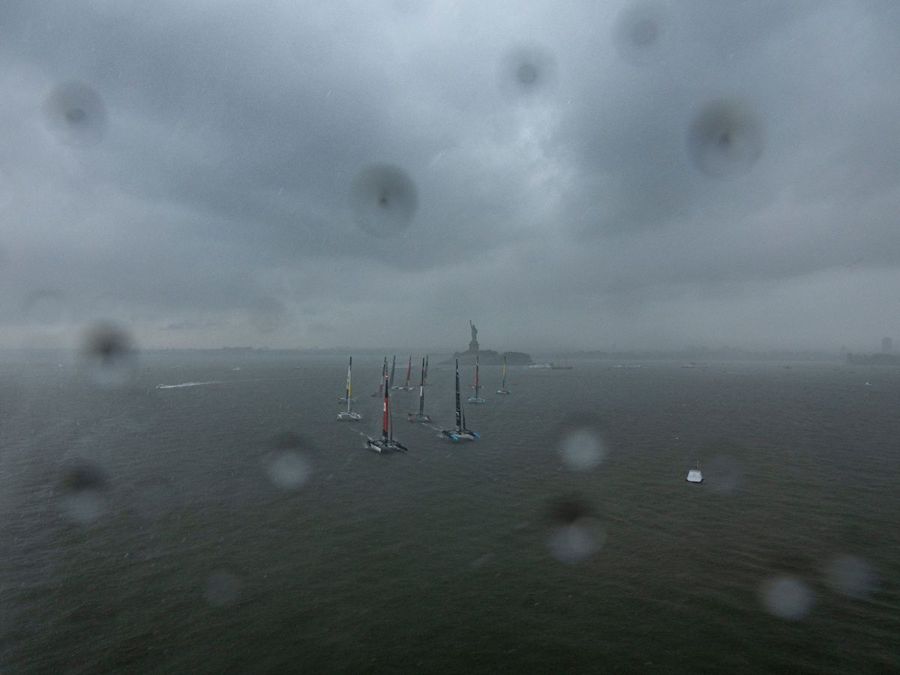 ROCKWOOL Denmark SailGP Team helmed by Nicolai Sehested and New Zealand SailGP Team helmed by Peter Burling lead the fleet in the pouring rain on Race Day 1 of the Mubadala New York Sail Grand Prix in New York, USA. Saturday 7 June 2025. Rolex SailGP Championship Event 6 Season 2025. Photo: Samo Vidic for SailGP. Handout image supplied by SailG