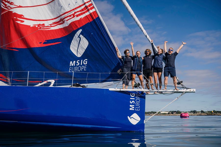 The Aotearoa Ocean Racing team proudly waving having comleted The Ocean Race Atlantic 2026