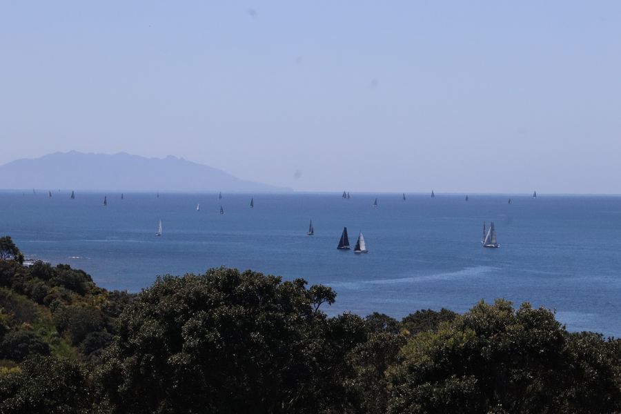 The 2026 PIC Coastal Classic fleet stretches out passed Whangaparaoa Peninsula towards Kawau Island.