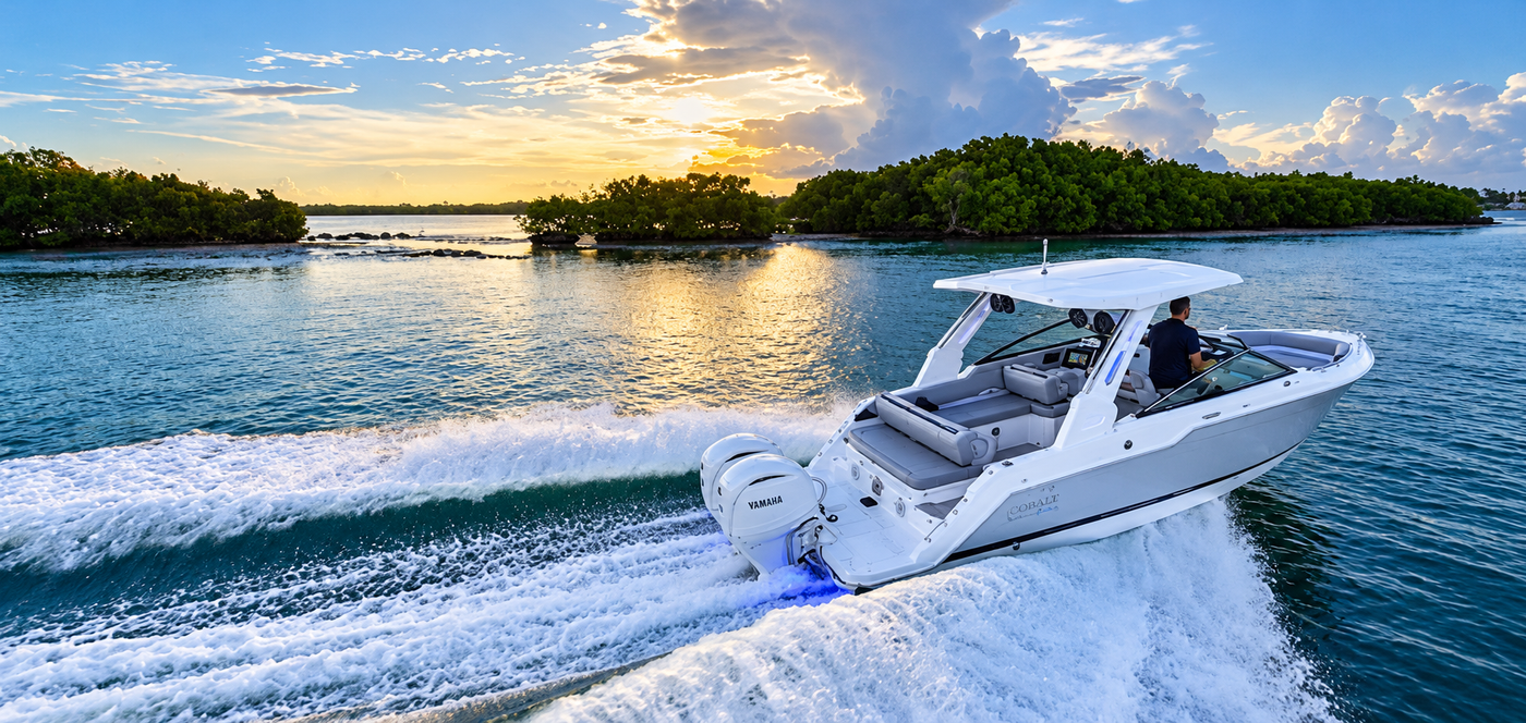 The 2027 Cobalt 265 Coastal Edition underway, with twin Yamaha outboards, a protective hardtop and an open cockpit designed for coastal cruising and days on the water.
