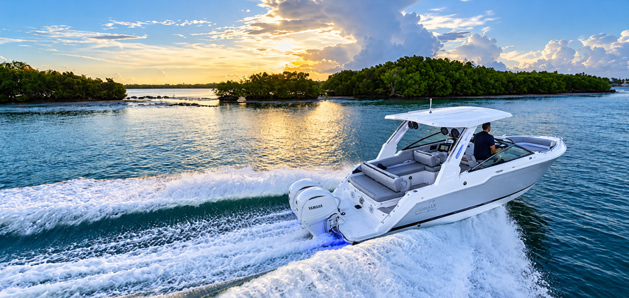 The 2027 Cobalt 265 Coastal Edition underway, with twin Yamaha outboards, a protective hardtop and an open cockpit designed for coastal cruising and days on the water.
