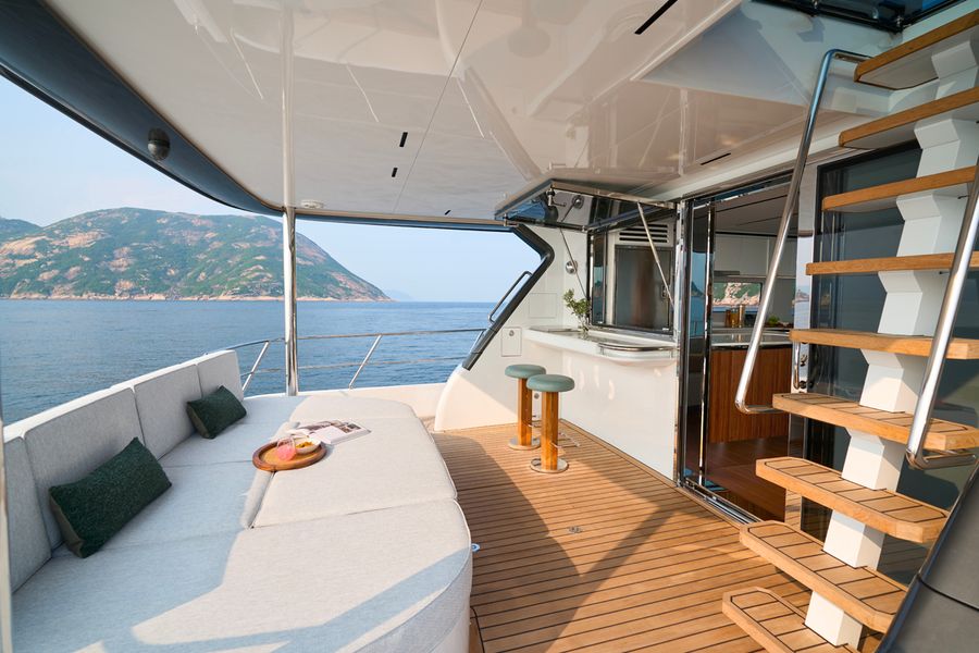 The CLB65 SUV’s aft lounge daybed, with bar stools at the galley’s flip-up window.