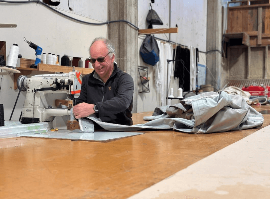 Bill Richards, Textile Fabricator, sewing a repair for a yacht Bimini at KJL Sails, Picton New Zealand. Media credit : The Whiskey Project and KJL Sails
