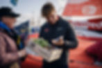 A Breton farmer offers local produce to Basile Bourgnon, skipper of Edenred on the Ocean Fifty class
