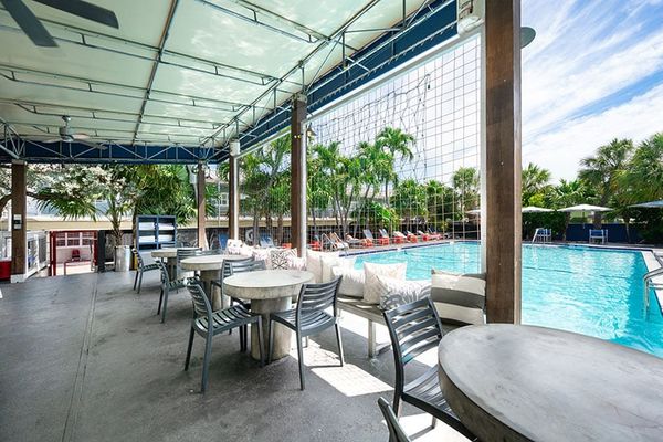 Tables dot the shaded pool deck at Blue Marlin Motel Key West