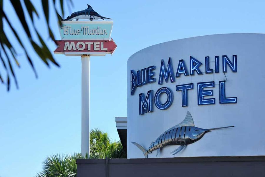 The Blue Marlin Motel's neon sign and marlin emblem stand out against a blue Key West sky