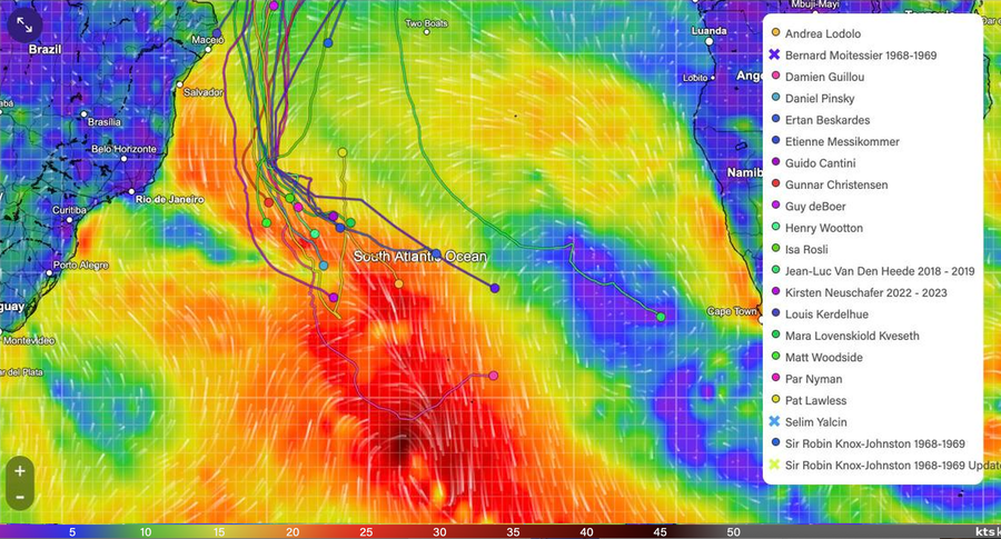 Wind map of the South Atlantic with the Golden Globe Race fleet, showing the leader's pink track beside the storm centre and the other yachts spread to the upper left.
