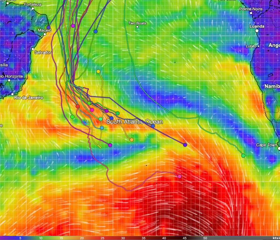 Wind map of the South Atlantic with the Golden Globe Race fleet, showing the leader's pink track beside a red storm centre and the other yachts clustered to the upper left.