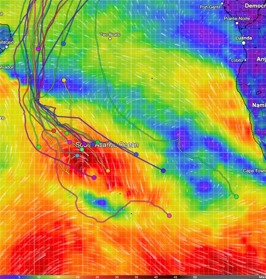 Wind map of the South Atlantic with the Golden Globe Race fleet, showing the leader's pink track south-east of the main cluster and a red storm area close by.