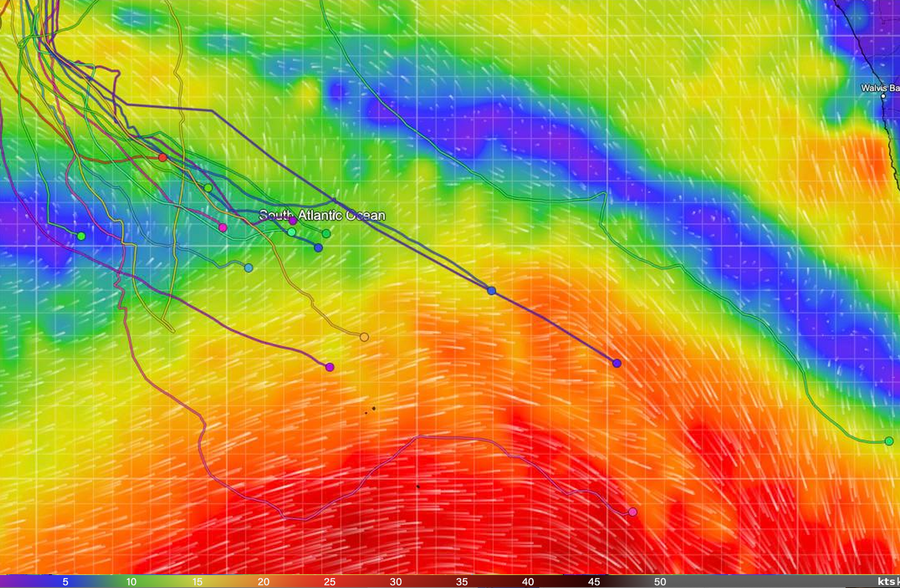 Wind map of the South Atlantic with the Golden Globe Race fleet, showing the leader's pink track in red strong-wind water to the south-east and the main fleet's tracks bunched in lighter green and blue air to the north-west.