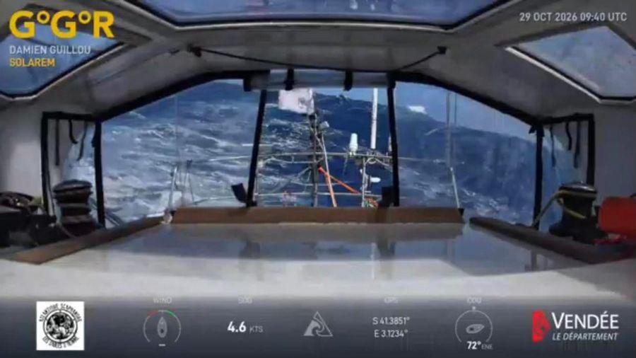 View aft from inside the saloon of Solarem through the companionway, showing a steep grey-blue swell and the mast and wind gear behind, with the overlay showing 4.6 knots at 41 degrees south.