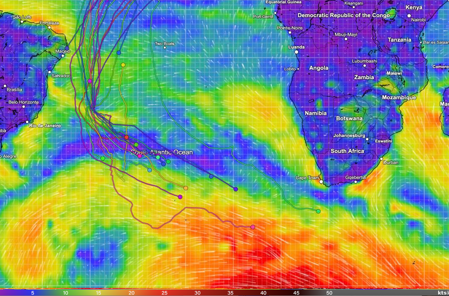 Wind map of the South Atlantic with the Golden Globe Race fleet, showing the leader's pink track in red strong-wind water to the south-east and the main fleet bunched in pale blue and green light air to the north-west.