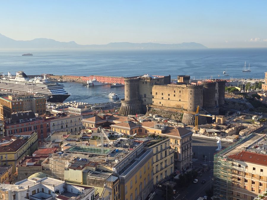 The Bay of Naples coastline, with the historic Castel Nuovo standing watch over the waterfront.