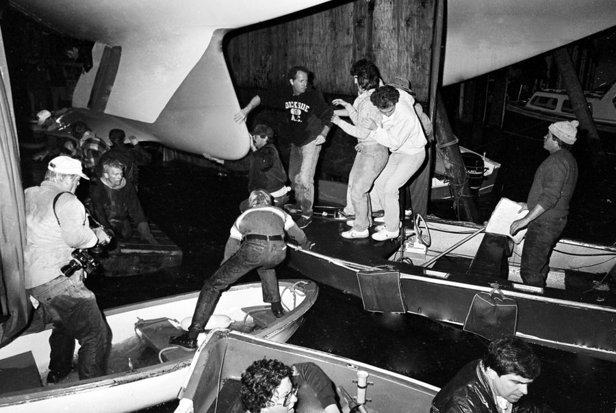 Members of the Australia II crew, skippered by John Bertrand, reveal the yacht's keel after their 1983 America's Cup win over Dennis Conner's Liberty.
