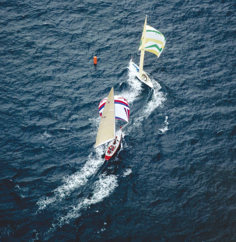 Alan Bond's Australia II, skippered by John Bertrand, leads Dennis Conner's Liberty around the leeward mark during the 1983 America's Cup in Newport, Rhode Island.
