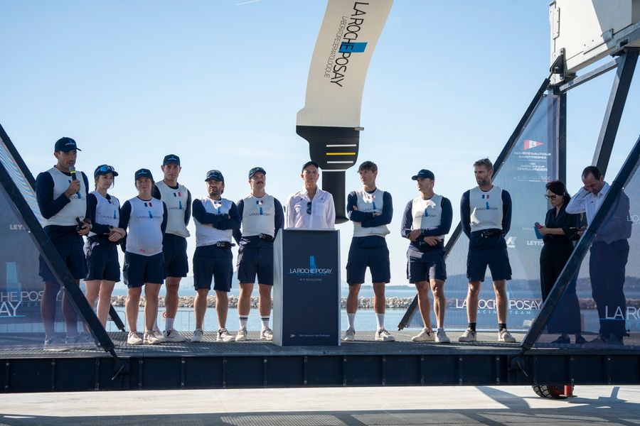 The sailing crew celebrates as La Roche-Posay becomes the first AC75 launched in the Gulf of Naples.