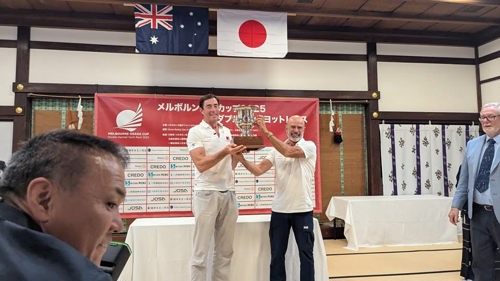 Alive co-skippers celebrate their Melbourne Osaka victory with the trophy.