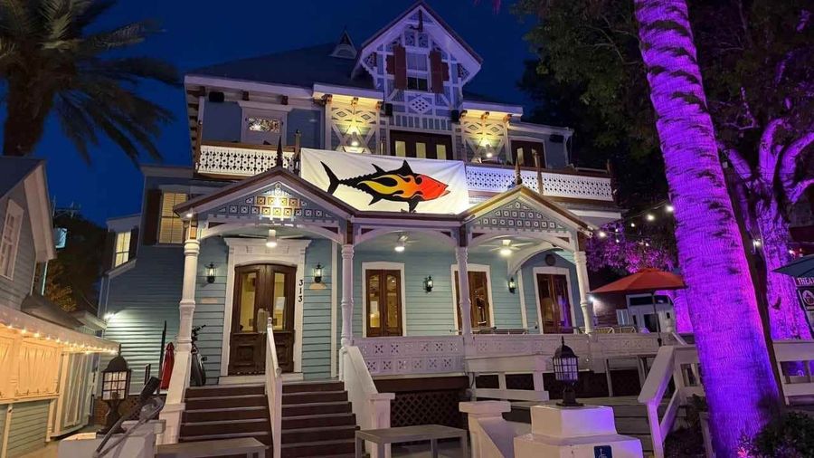 The Smokin' Tuna Saloon glows at night at the historic Robert Curry Mansion, 313 Duval Street, Key West