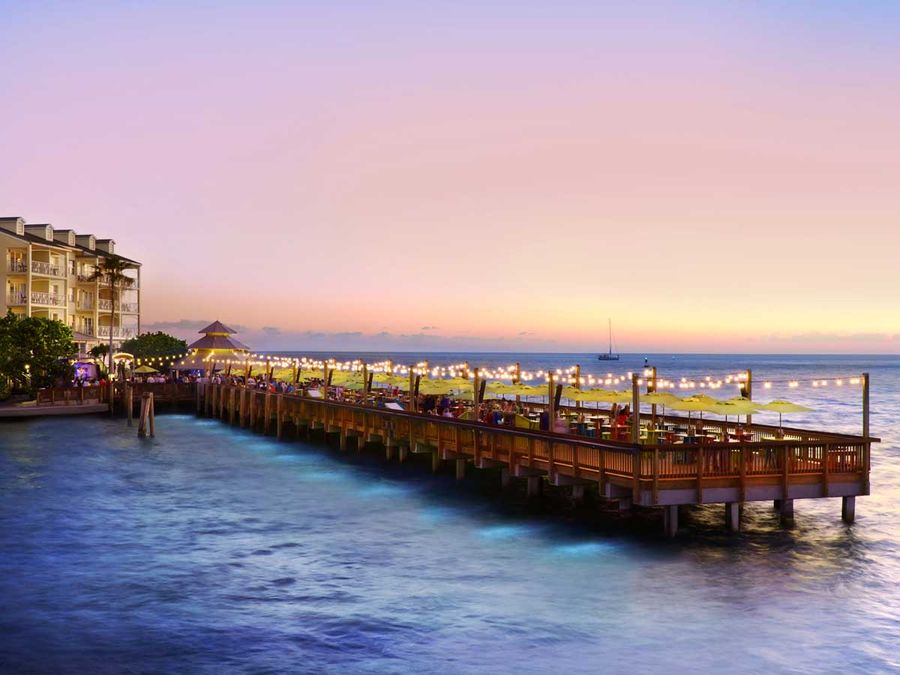 Sunset Pier at Ocean Key Resort glows at dusk over the Gulf of Mexico