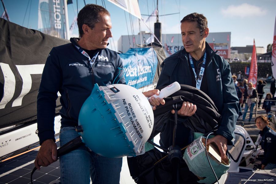 Noé Poffa, Ifremer, and CNES representatives are pictured with Fortinet - Best Western skipper Romain Attanasio (FRA) while distributing scientific tools in coordination with UNESCO, to skippers before start of the Vendee Globe, on October 22, 2024 in Les Sables d'Olonne, France - (Photo by Anne Beauge / Alea)